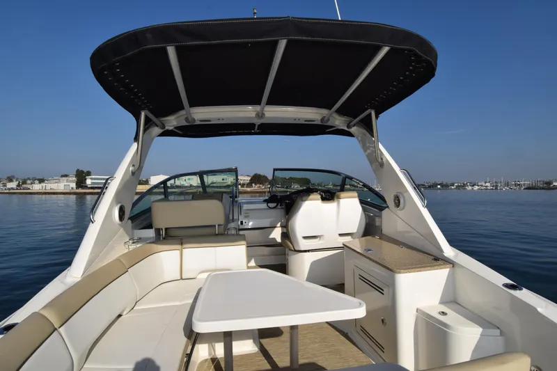 Just Plane Fun Yacht Photos Pics 2014 Sea Ray 350 Sundancer boat interior with seating and table on calm water.