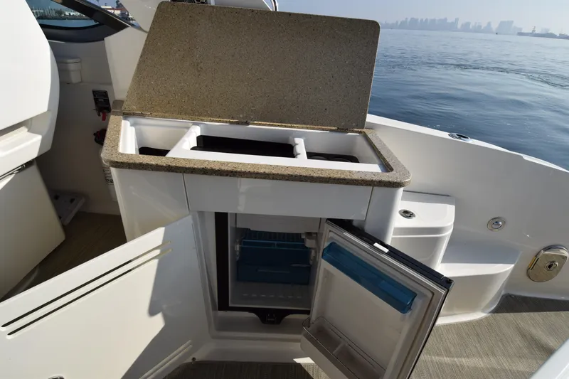 Just Plane Fun Yacht Photos Pics 2014 Sea Ray 350 Sundancer boat kitchenette with open fridge, sink, and countertop.
