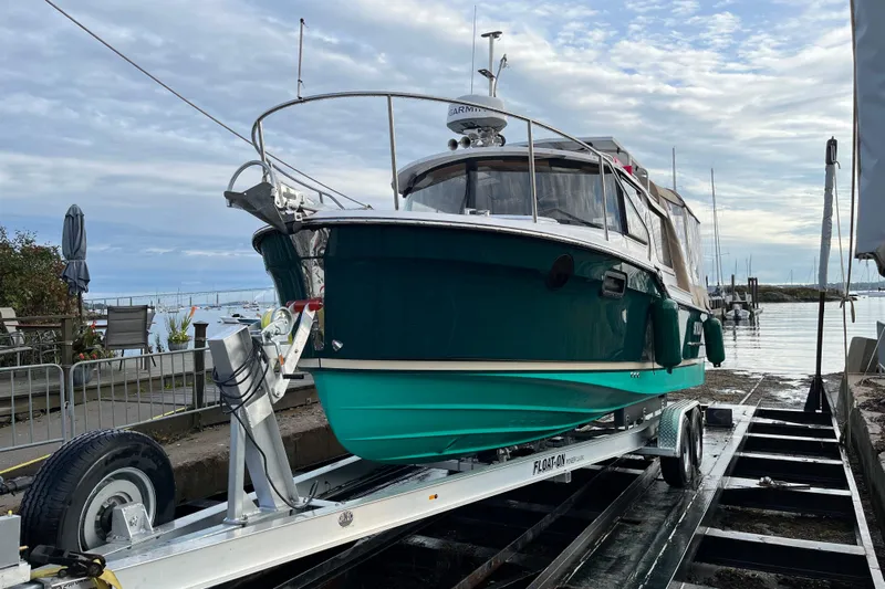 Skylark Yacht Photos Pics 2025 Ranger Tugs R23 boat on trailer by waterfront, ready for launch.