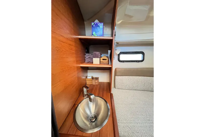 Skylark Yacht Photos Pics Interior of 2025 Ranger Tugs R23 with sink, shelves, and window.
