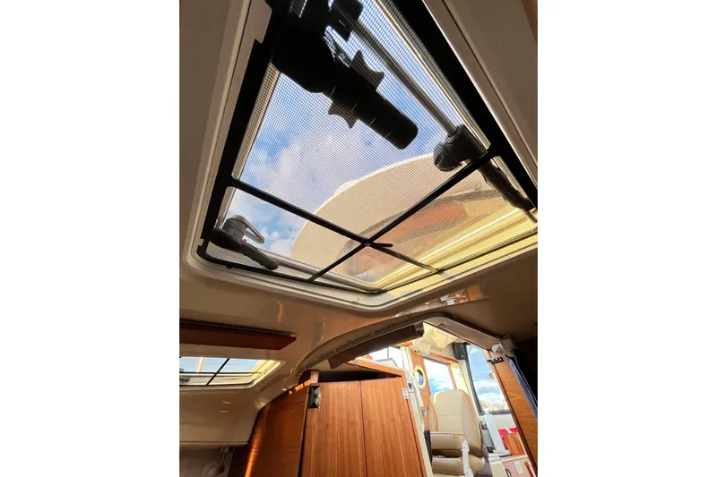Skylark Yacht Photos Pics Interior view of 2025 Ranger Tugs R23, featuring a skylight and wooden cabin details.