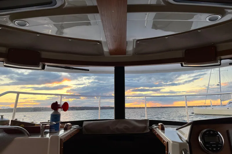 Skylark Yacht Photos Pics Interior view from 2025 Ranger Tugs R23 boat, overlooking sunset on the water.
