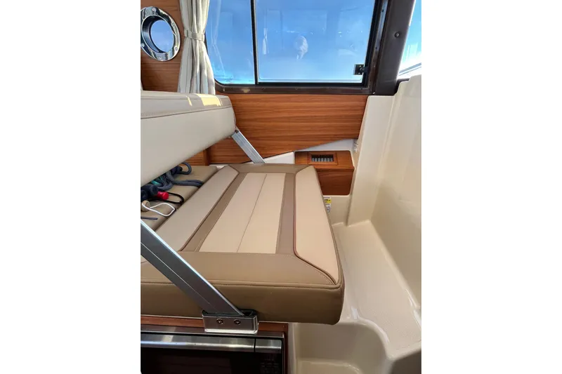 Skylark Yacht Photos Pics 2025 Ranger Tugs R23 interior with beige seating and wood accents.