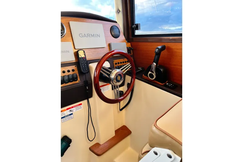 Skylark Yacht Photos Pics Helm of 2025 Ranger Tugs R23 with Garmin navigation and wooden steering wheel.