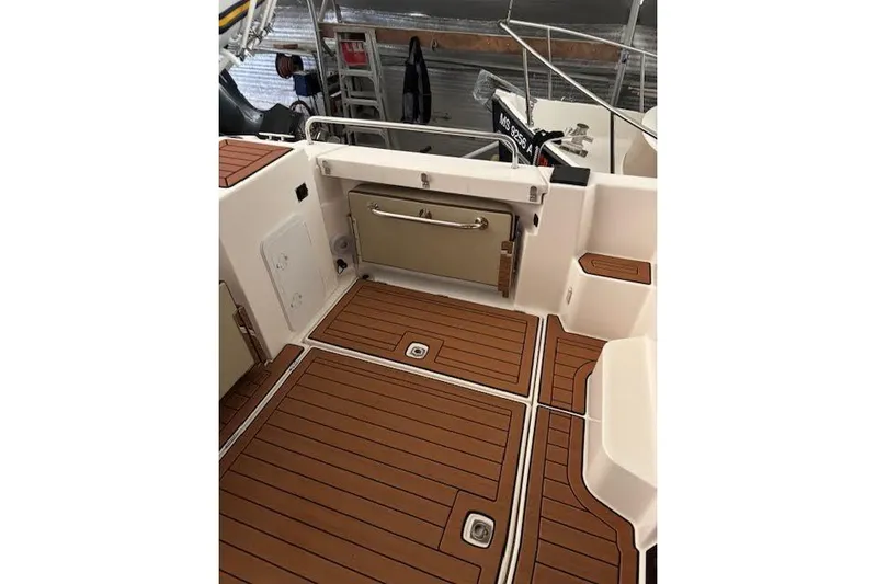 Skylark Yacht Photos Pics 2025 Ranger Tugs R23 boat deck with teak flooring and storage compartments.