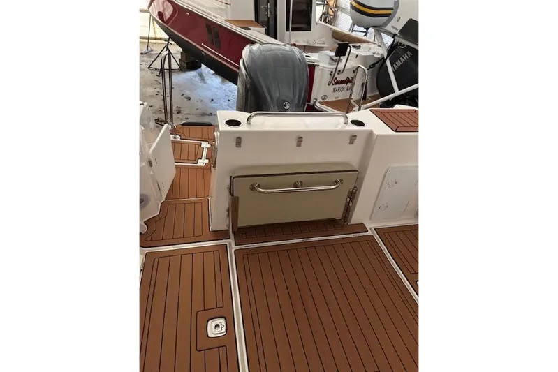 Skylark Yacht Photos Pics 2025 Ranger Tugs R23 boat deck with teak flooring and Yamaha outboard motor.