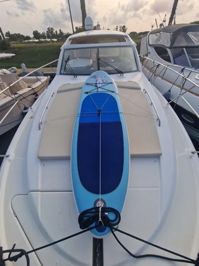  Yacht Photos Pics 2008 Jeanneau Prestige 38 S with surfboard on deck, docked at marina.