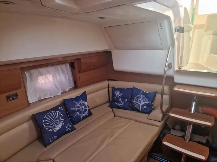  Yacht Photos Pics Interior of 2008 Jeanneau Prestige 38 S yacht with beige seating and nautical-themed cushions.