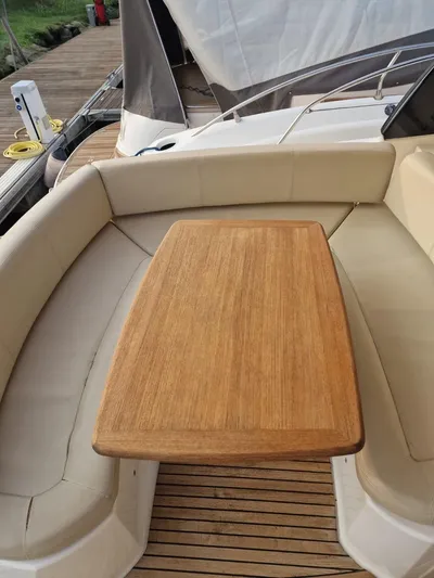  Yacht Photos Pics 2008 Jeanneau Prestige 38 S yacht with teak table and cushioned seating.