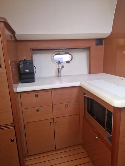  Yacht Photos Pics 2008 Jeanneau Prestige 38 S yacht kitchen with wood cabinets and modern appliances.
