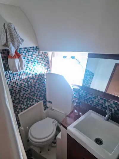  Yacht Photos Pics Bathroom interior of 2008 Jeanneau Prestige 38 S yacht with mosaic tiles and compact fixtures.