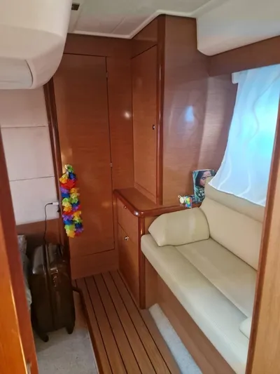  Yacht Photos Pics Interior of 2008 Jeanneau Prestige 38 S yacht with wooden paneling and beige seating.