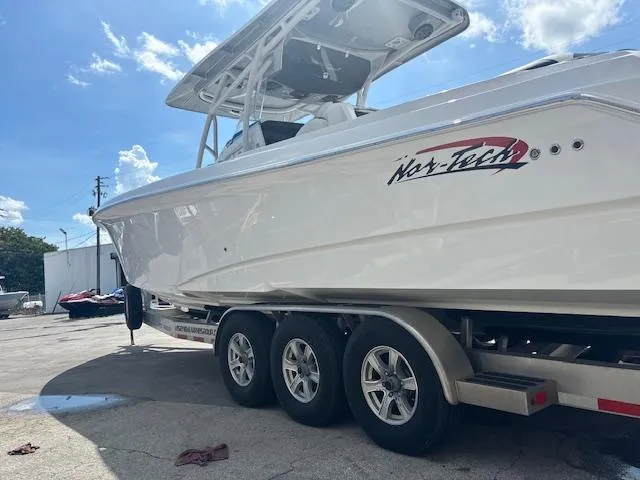  Yacht Photos Pics 2019 Nor-Tech 340 Sport Center Console boat on trailer under blue sky.