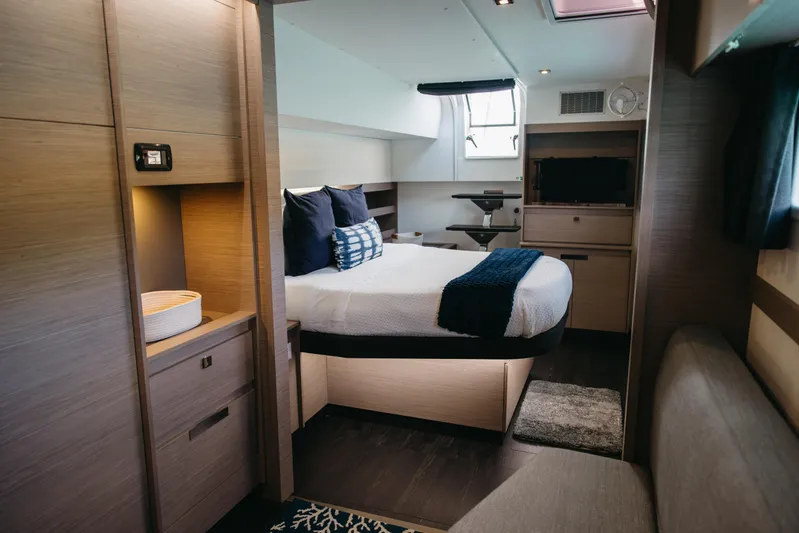 Amajen Yacht Photos Pics Luxurious cabin interior of 2022 Fountaine Pajot Aura 51 yacht, featuring modern design and cozy bedding.