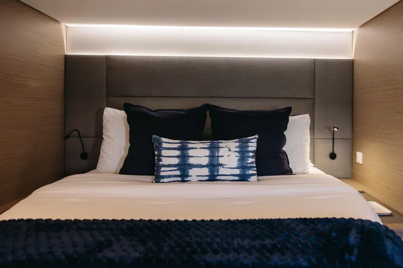 Amajen Yacht Photos Pics Luxurious bedroom interior on 2022 Fountaine Pajot Aura 51 yacht, featuring modern design and ambient lighting.