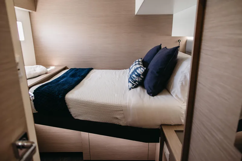 Amajen Yacht Photos Pics Luxurious bedroom interior of 2022 Fountaine Pajot Aura 51 yacht with elegant bedding.