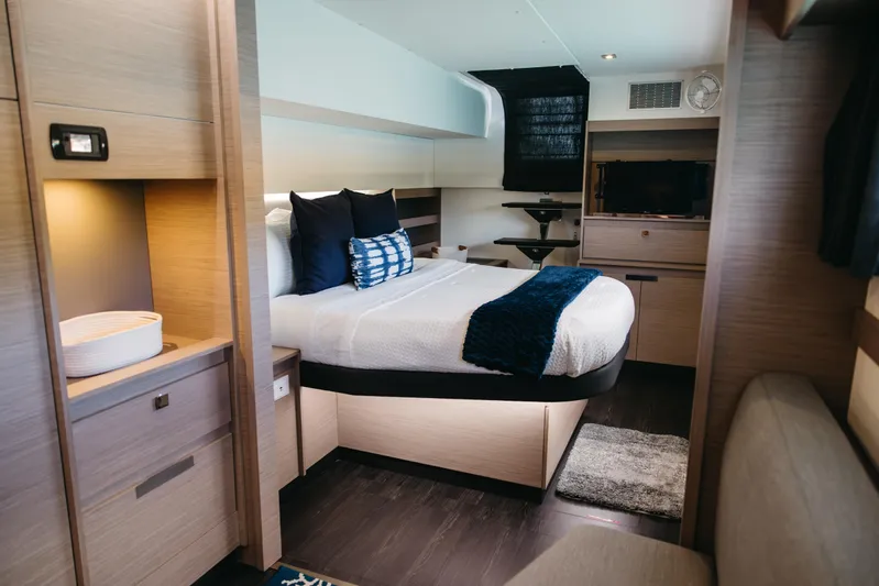 Amajen Yacht Photos Pics Luxurious bedroom interior of 2022 Fountaine Pajot Aura 51 yacht, featuring modern design and cozy bedding.