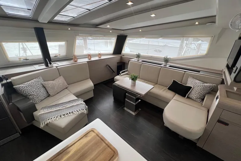 Amajen Yacht Photos Pics Luxurious interior of 2022 Fountaine Pajot Aura 51 catamaran with modern seating and decor.