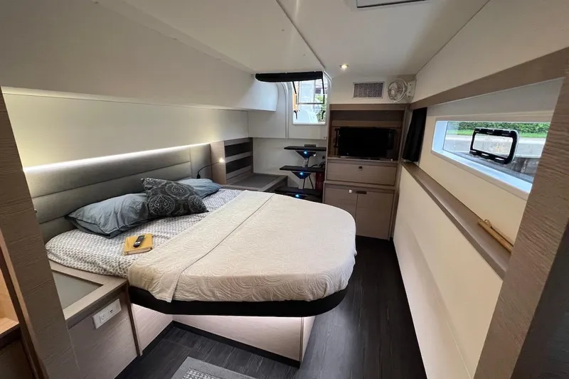 Amajen Yacht Photos Pics Luxurious cabin interior of 2022 Fountaine Pajot Aura 51 yacht, featuring modern design and cozy bedding.