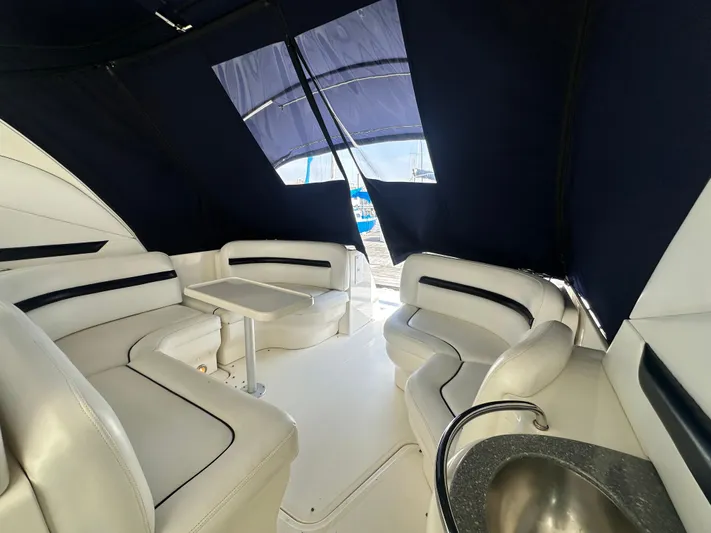 Bad Kitty Yacht Photos Pics Interior of 2007 Sea Ray 380 Sundancer with white seating and table.