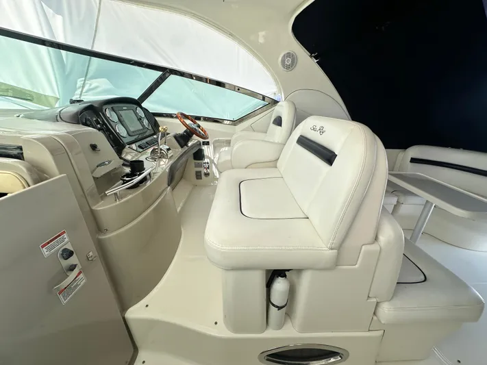 Bad Kitty Yacht Photos Pics Interior of 2007 Sea Ray 380 Sundancer with white seating and control panel.