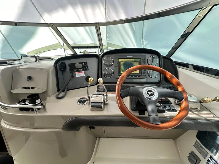 Bad Kitty Yacht Photos Pics 2007 Sea Ray 380 Sundancer helm with wood steering wheel and navigation controls.