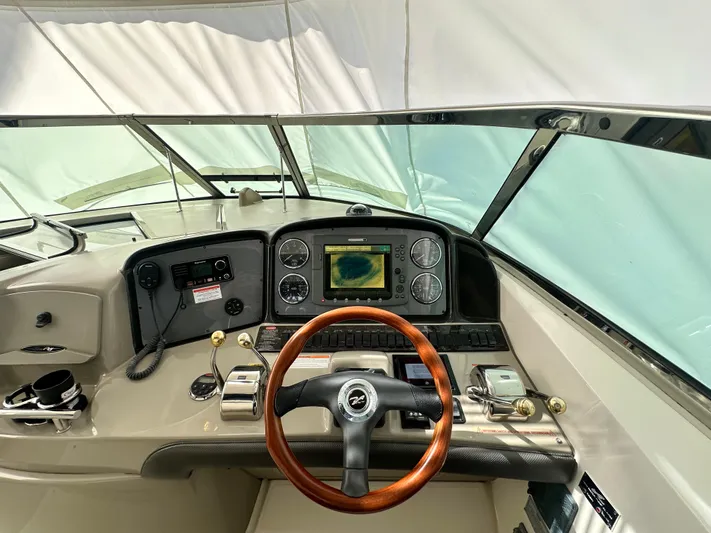 Bad Kitty Yacht Photos Pics Helm of 2007 Sea Ray 380 Sundancer with wood steering wheel and navigation system.