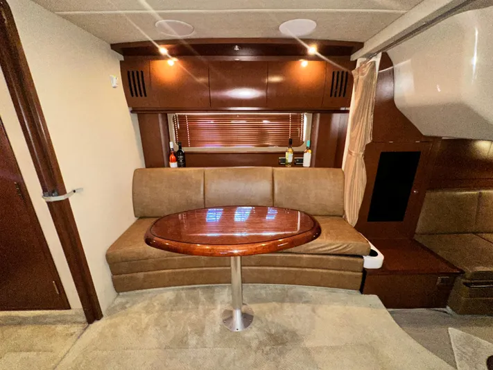 Bad Kitty Yacht Photos Pics Luxurious 2007 Sea Ray 380 Sundancer interior with elegant seating and wooden table.
