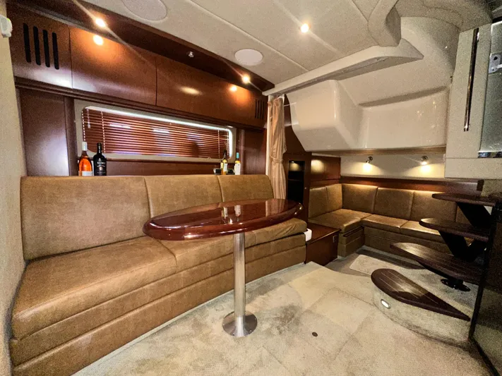 Bad Kitty Yacht Photos Pics Luxurious interior of 2007 Sea Ray 380 Sundancer yacht with elegant seating and wooden table.