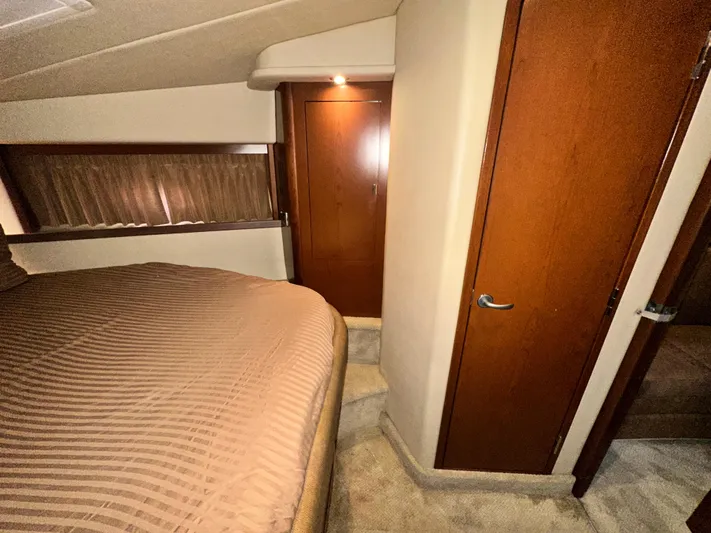 Bad Kitty Yacht Photos Pics Interior cabin of 2007 Sea Ray 380 Sundancer with wood paneling and bed.