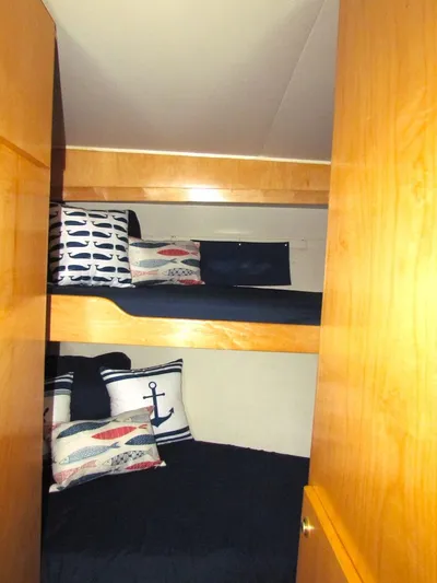  Yacht Photos Pics Bunk beds with nautical-themed pillows in a 1998 Navigator 53 yacht cabin.