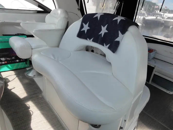  Yacht Photos Pics Interior of 2003 Sea Ray 380 Sundancer with white seating and star-patterned blanket.