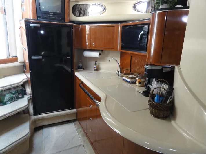  Yacht Photos Pics 2003 Sea Ray 380 Sundancer yacht kitchen with modern appliances and wooden cabinetry.