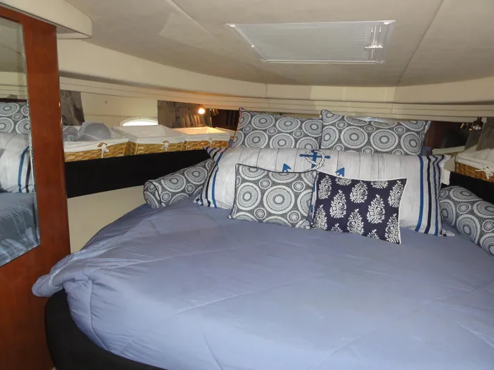  Yacht Photos Pics Luxurious cabin interior of 2003 Sea Ray 380 Sundancer with plush bedding and decorative pillows.