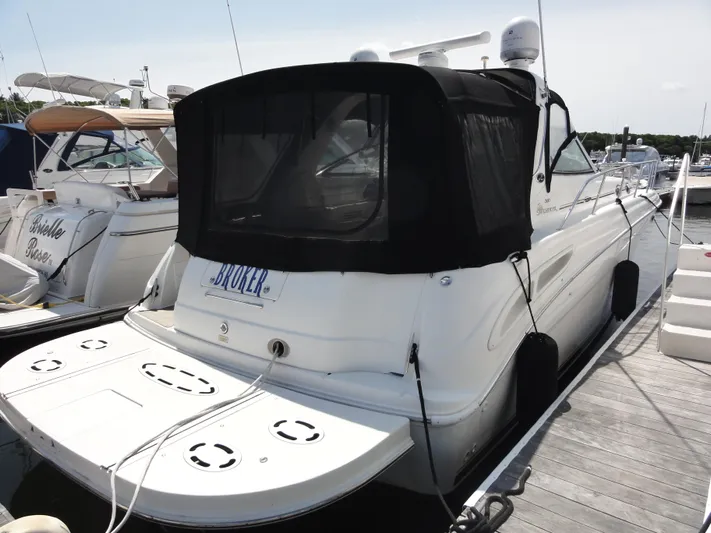  Yacht Photos Pics 2003 Sea Ray 380 Sundancer docked at marina, rear view with black canopy.