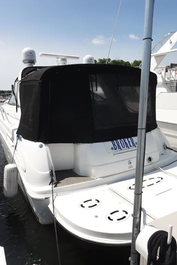  Yacht Photos Pics 2003 Sea Ray 380 Sundancer yacht docked, featuring a black canopy and white hull.