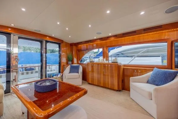 Volare Yacht Photos Pics Luxurious interior of 2006 Hatteras 64 Motor Yacht with elegant seating and wood finishes.