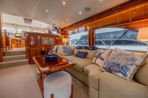 Volare Yacht Photos Pics Luxurious interior of 2006 Hatteras 64 Motor Yacht with plush seating and elegant decor.