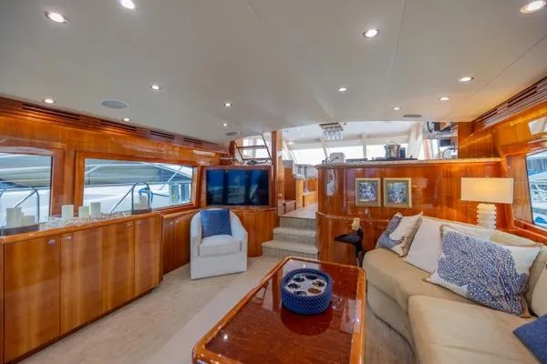 Volare Yacht Photos Pics Luxurious interior of 2006 Hatteras 64 Motor Yacht with elegant wood finishes and plush seating.