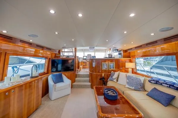Volare Yacht Photos Pics Luxurious interior of 2006 Hatteras 64 Motor Yacht with plush seating and elegant wood finishes.