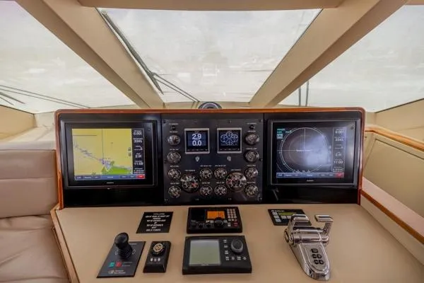 Volare Yacht Photos Pics Helm of 2006 Hatteras 64 Motor Yacht with navigation screens and controls.