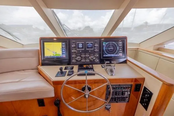 Volare Yacht Photos Pics Helm of 2006 Hatteras 64 Motor Yacht with navigation screens and controls.