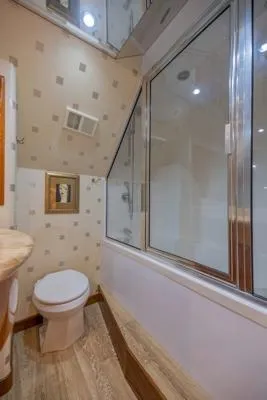 Volare Yacht Photos Pics Bathroom interior of 2006 Hatteras 64 Motor Yacht with modern fixtures and large window.