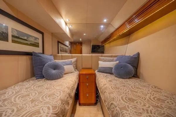 Volare Yacht Photos Pics Luxurious twin cabin in 2006 Hatteras 64 Motor Yacht with elegant decor and plush bedding.