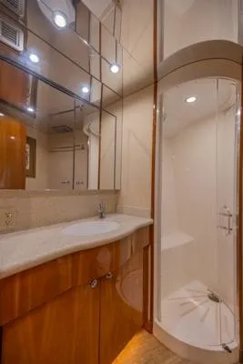 Volare Yacht Photos Pics Luxurious bathroom in 2006 Hatteras 64 Motor Yacht with modern shower and vanity.