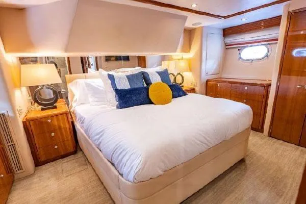 Volare Yacht Photos Pics Luxurious bedroom interior of 2006 Hatteras 64 Motor Yacht with elegant furnishings.