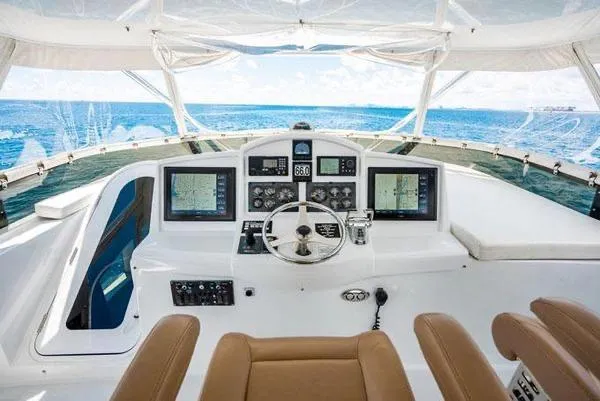 Volare Yacht Photos Pics Helm of 2006 Hatteras 64 Motor Yacht with ocean view and navigation equipment.