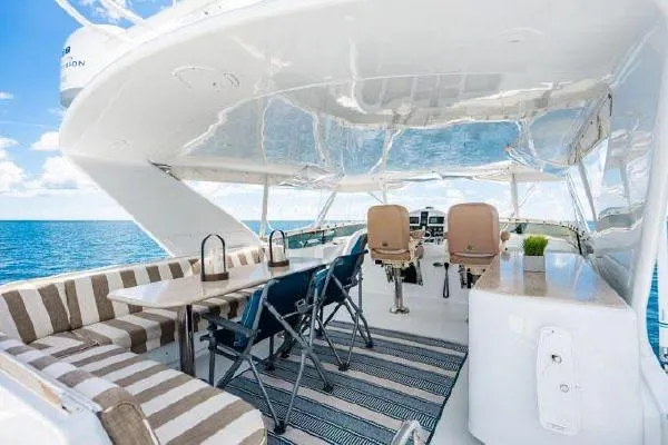 Volare Yacht Photos Pics 2006 Hatteras 64 Motor Yacht deck with seating, table, and ocean view.