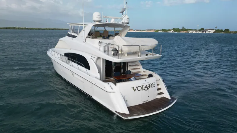 Volare Yacht Photos Pics 2006 Hatteras 64 Motor Yacht on open water, rear view, clear sky.