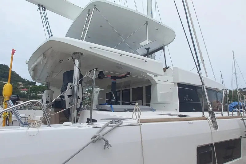 Amea Yacht Photos Pics 2014 Lagoon 52 F catamaran docked, showcasing sleek design and spacious deck.